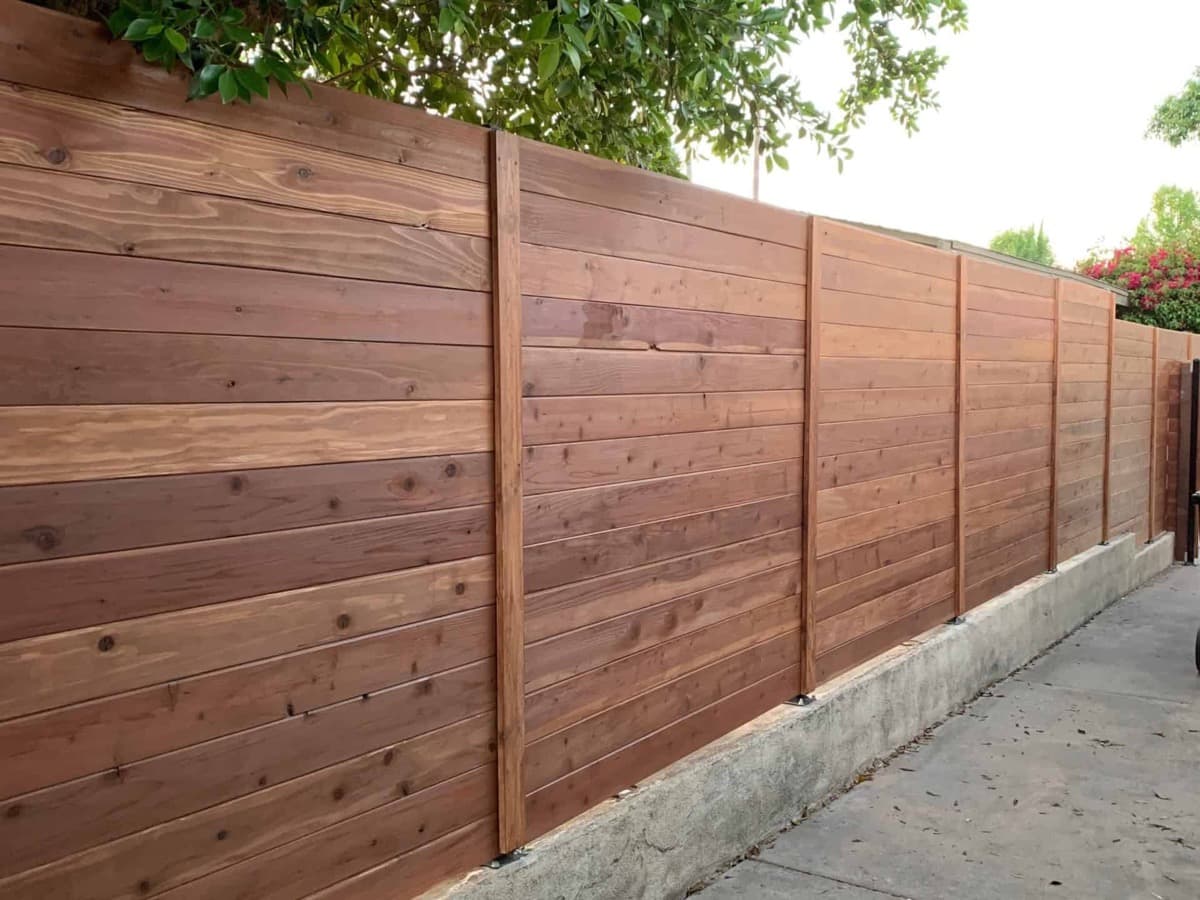 Horizontal tongue and groove fence stained by EVN Handyman — Portland Metro fence staining